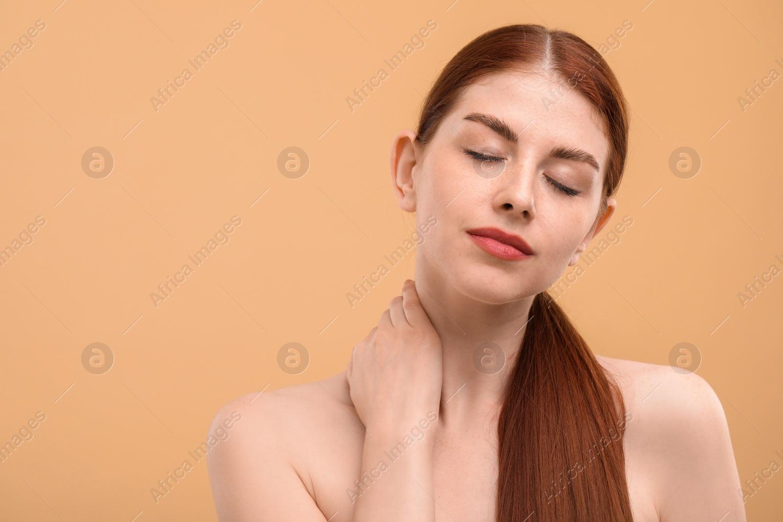 Photo of Portrait of beautiful woman with freckles on beige background. Space for text