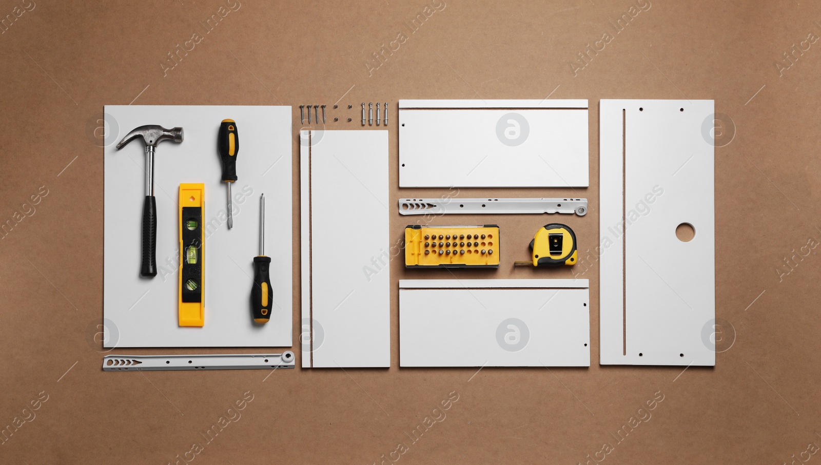 Photo of Flat lay composition with furniture parts and tools for self-assembly on brown background