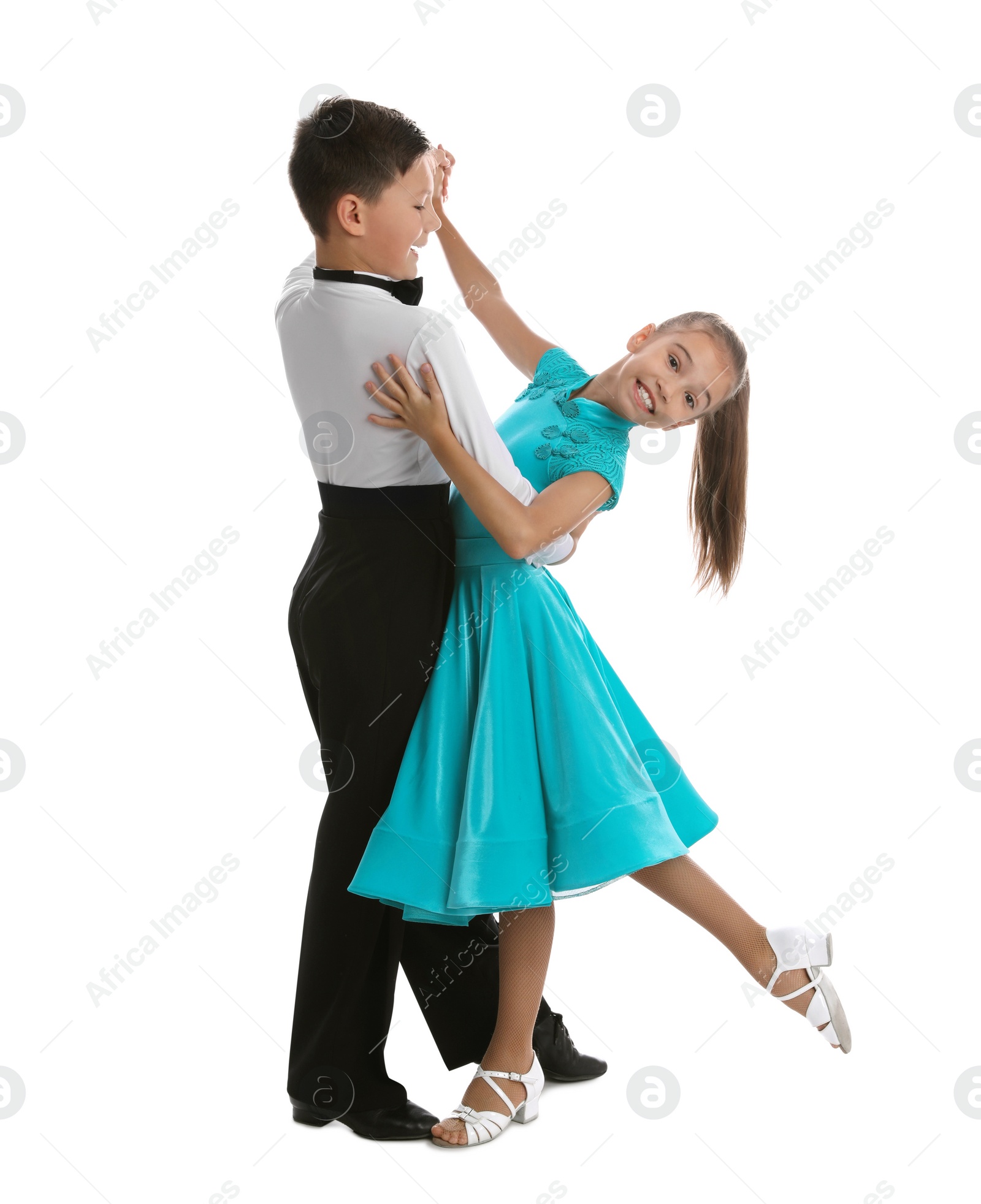 Photo of Beautifully dressed couple of kids dancing on white background