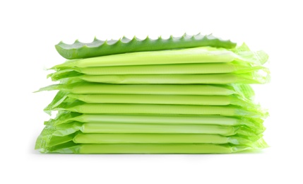 Stack of menstrual pads and aloe leaf on white background. Gynecological care