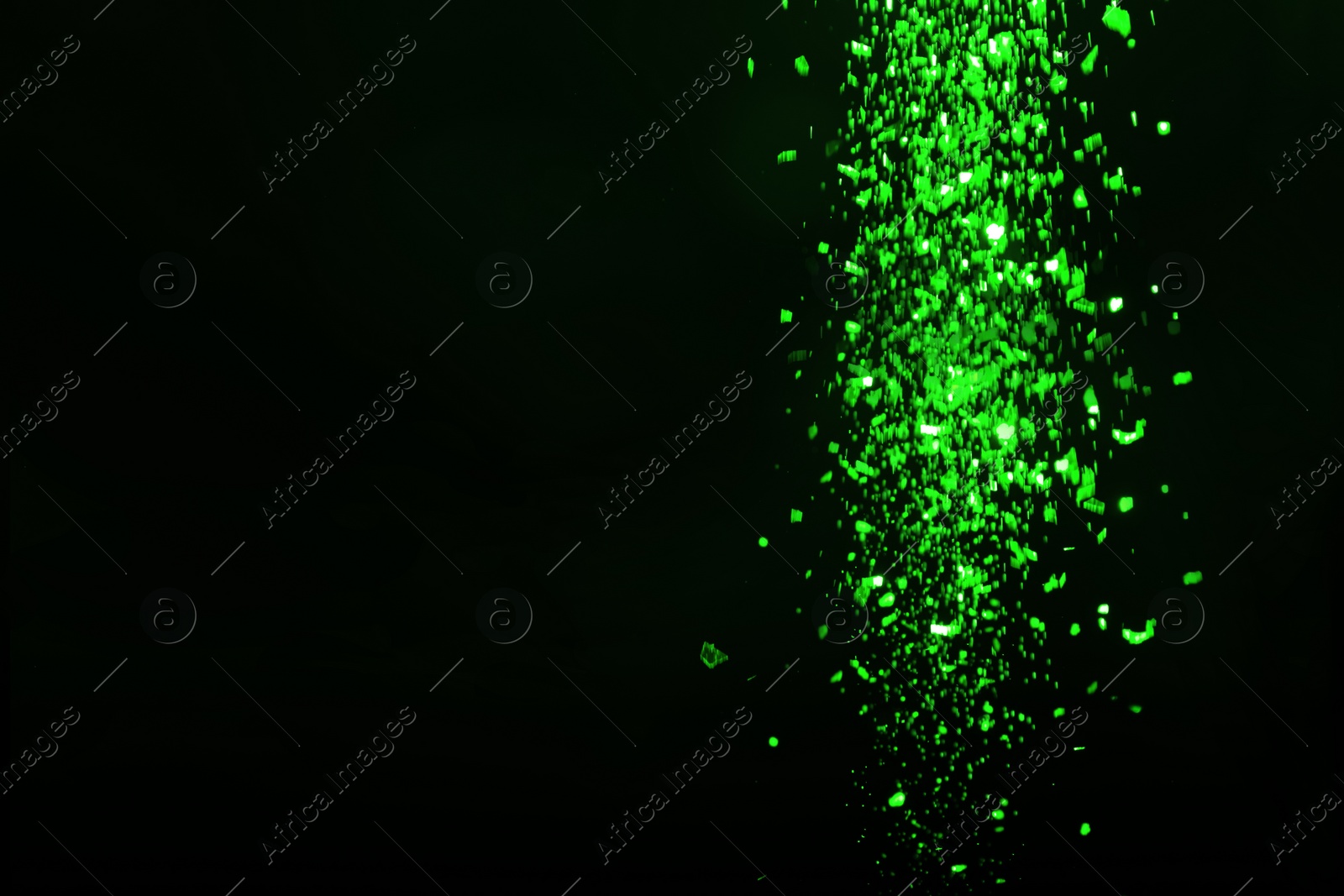 Image of St. Patrick day. Shiny green glitter on black background, bokeh effect