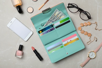 Photo of Flat lay composition with stylish wallet, smartphone and accessories on light background