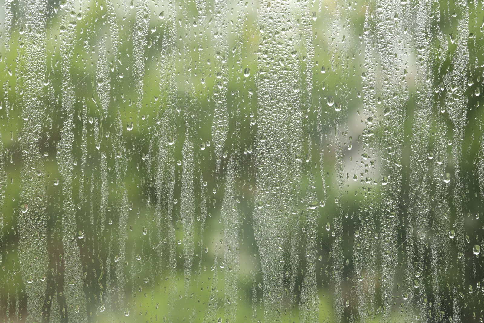 Photo of Window glass with raindrops as background, closeup