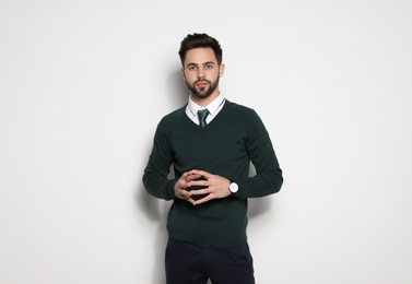 Photo of Portrait of handsome young man on light background