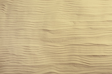 Photo of Dry beach sand as background, top view