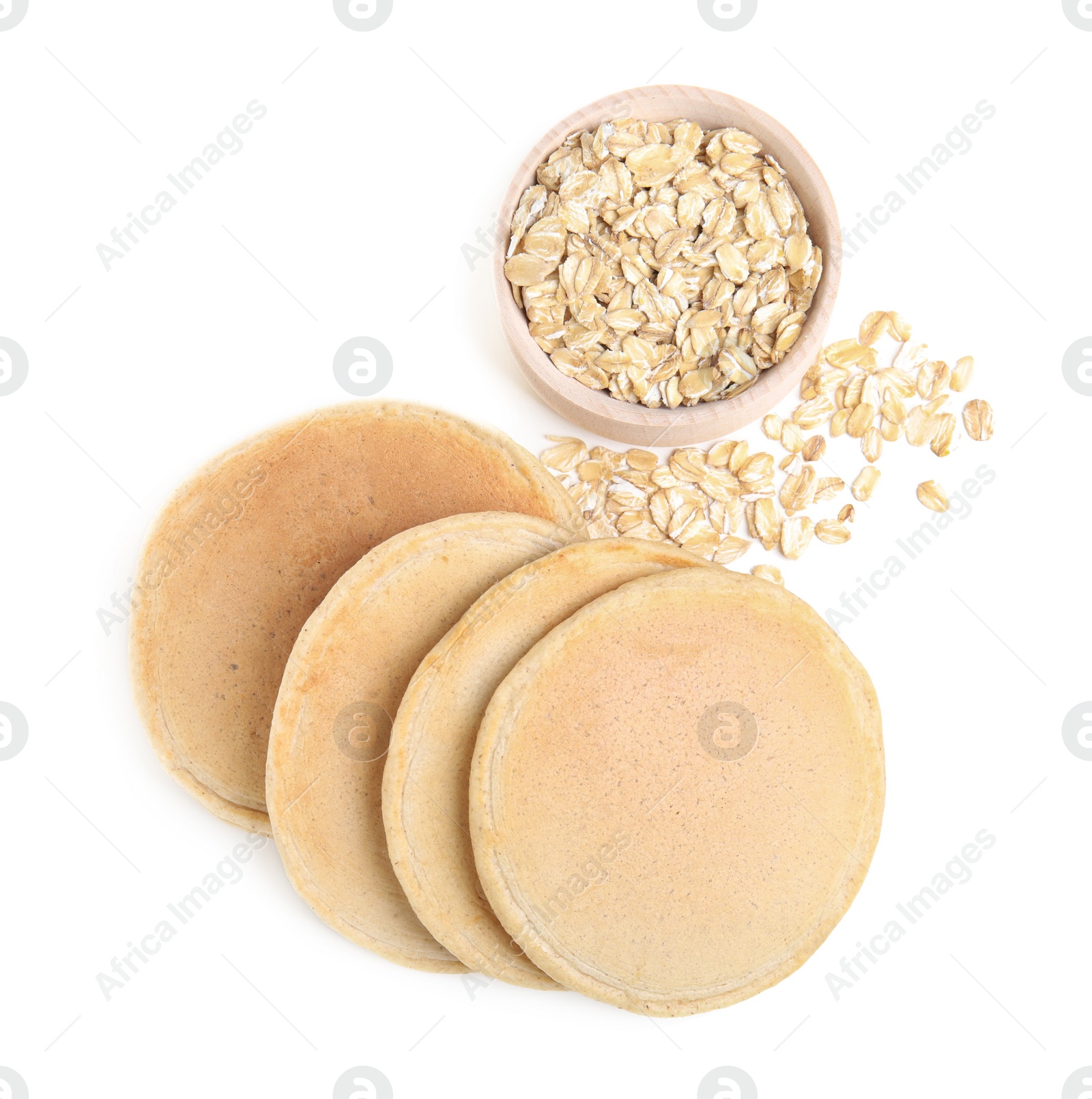 Photo of Tasty oatmeal pancakes and flakes on white background, top view