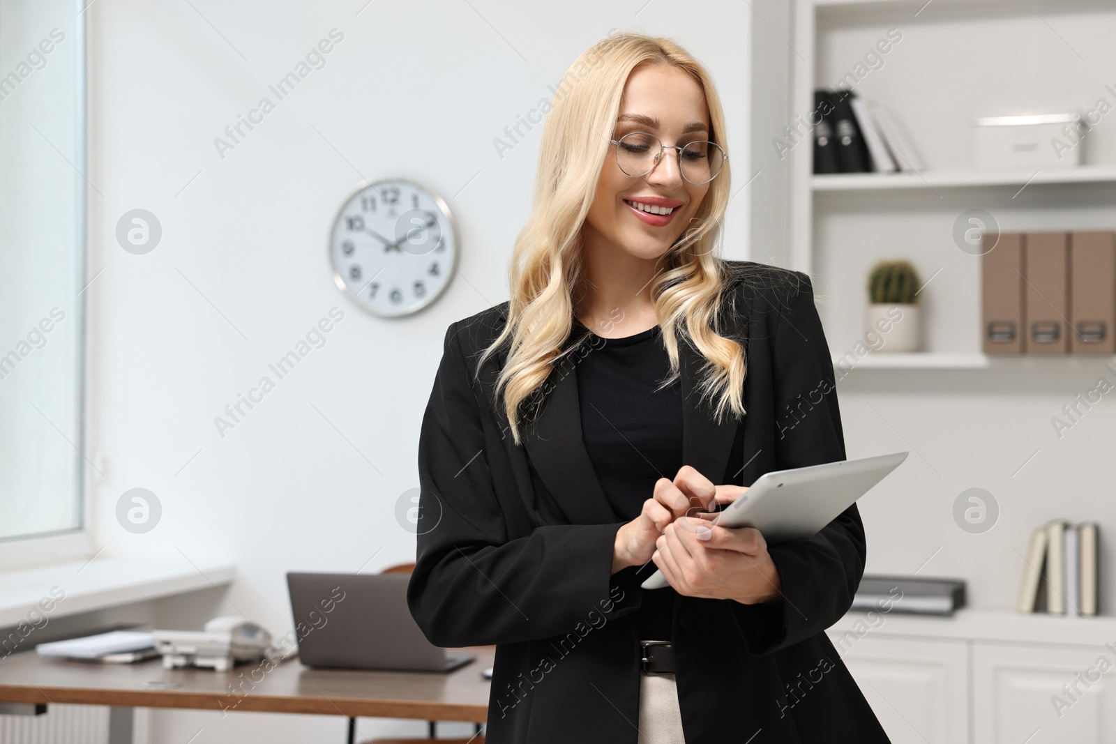 Photo of Happy secretary with tablet in office, space for text