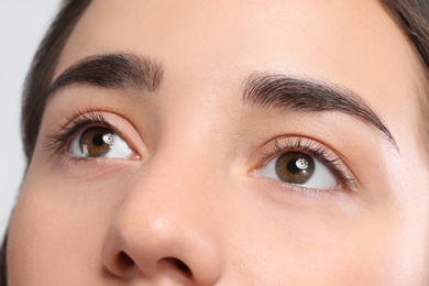 Photo of Young woman with beautiful natural eyelashes, closeup view