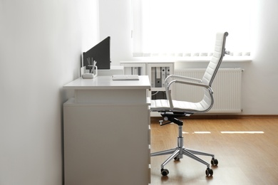 Stylish workplace interior with modern office chair and desk