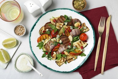 Photo of Delicious salad with beef tongue, grilled vegetables, peach and blue cheese on white table, flat lay