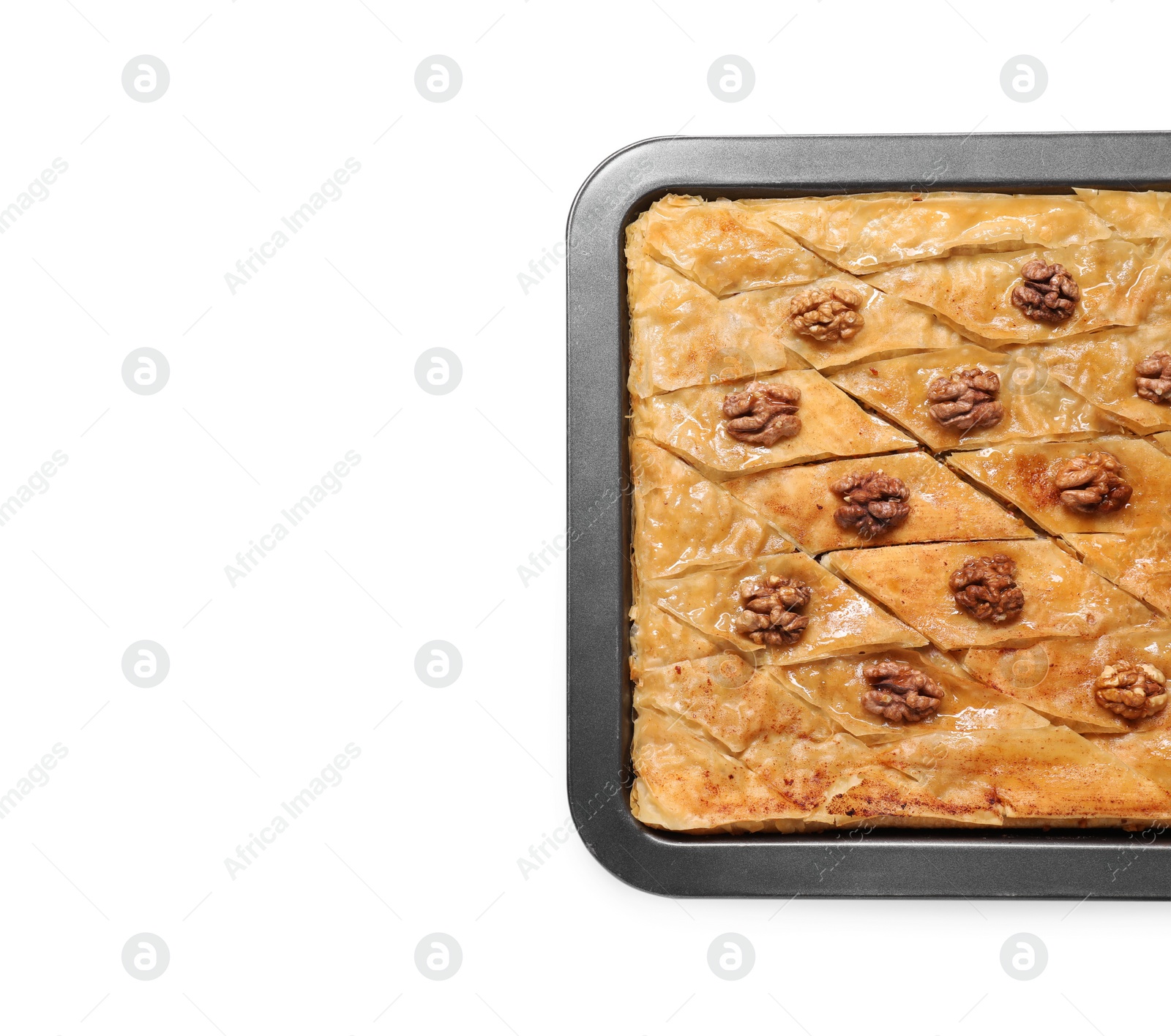 Photo of Delicious baklava with walnuts in baking pan isolated on white, top view