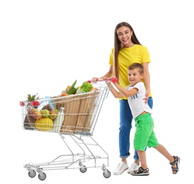 Photo of Mother and son with full shopping cart on white background