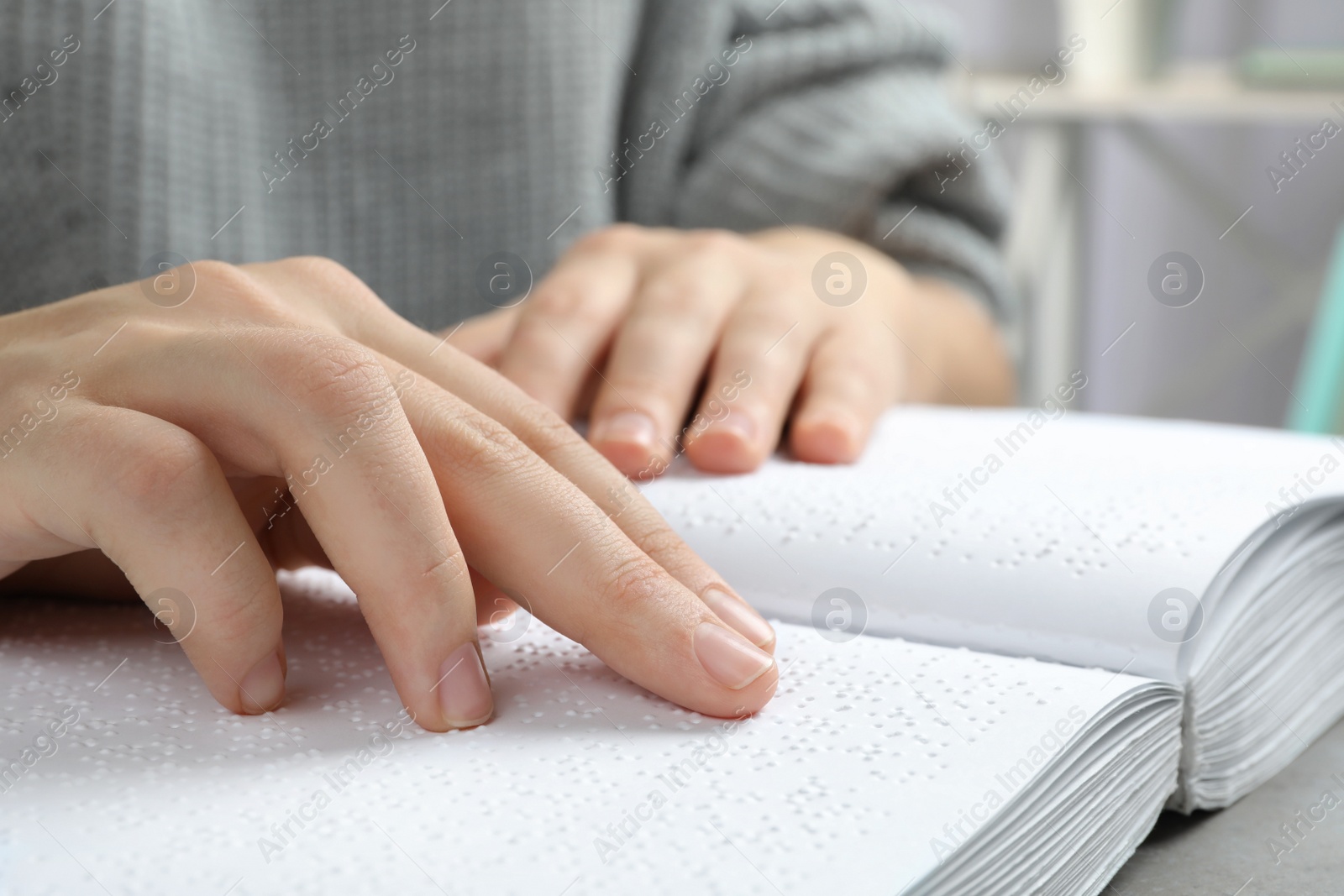 Photo of Blind person reading book written in Braille, closeup