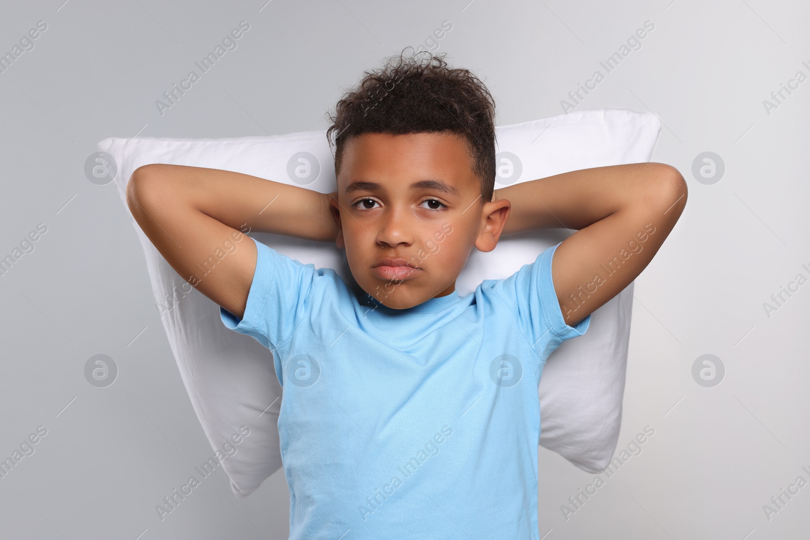 Photo of Boy with pillow on grey background. Insomnia problem