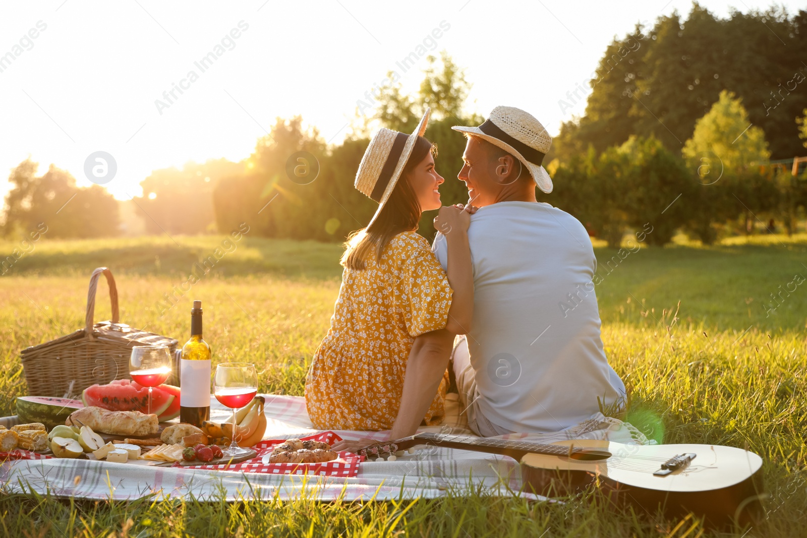 Photo of Happy couple having picnic in park on sunny day