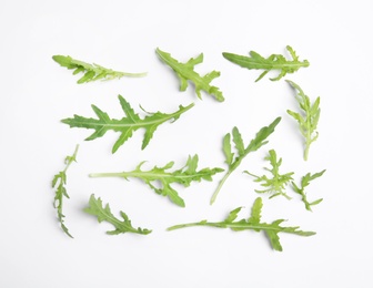 Photo of Fresh arugula on white background, flat lay