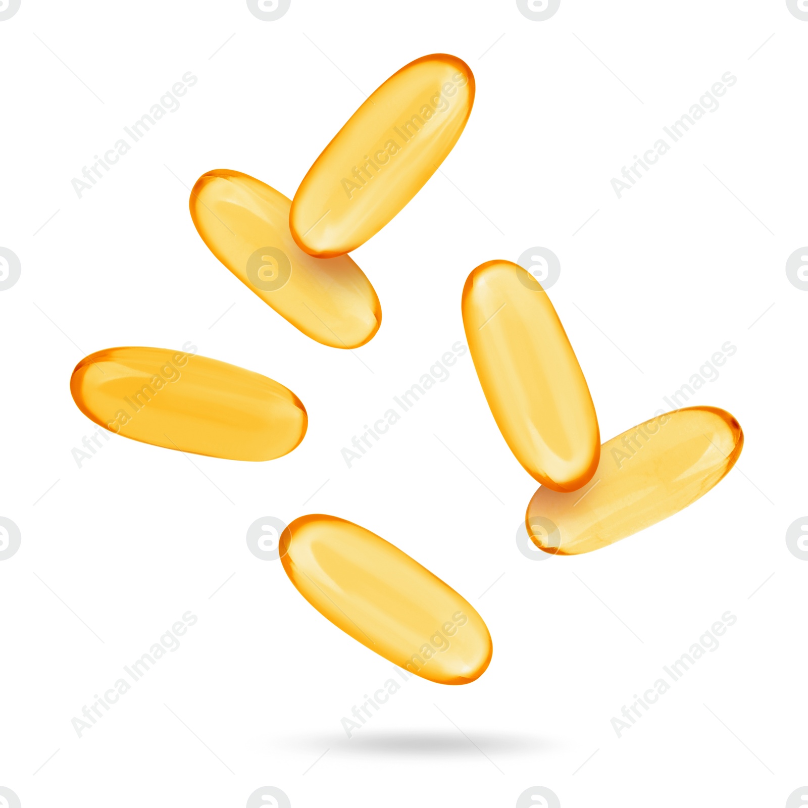 Image of Vitamin. Softgel capsules falling on white background