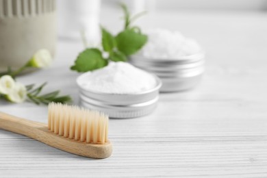 Photo of Toothbrush, dental products and herbs on white wooden table, closeup. Space for text