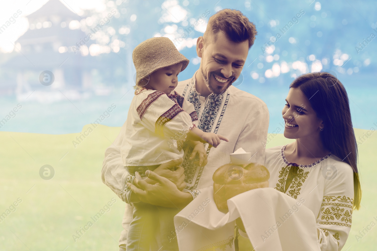 Image of Double exposure of happy family wearing national clothes with bread and salt and Ukrainian flag