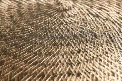 Beautiful golden textured surface as background, closeup