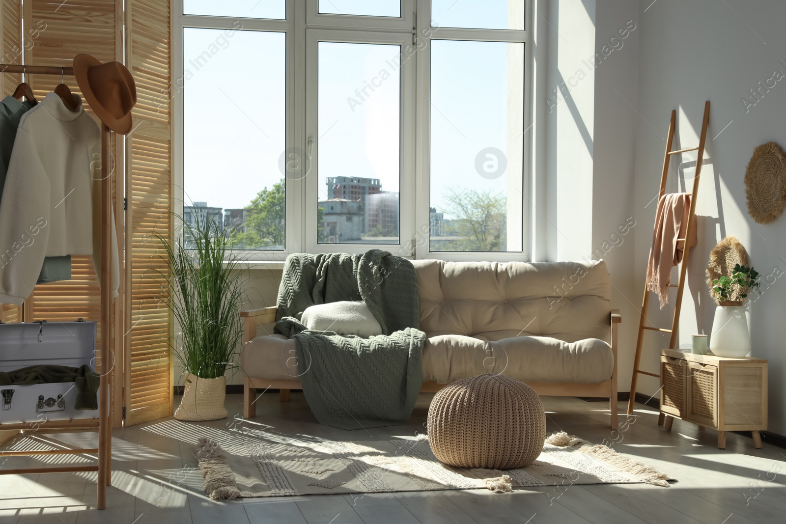Photo of Beautiful room with big window and furniture. Stylish interior