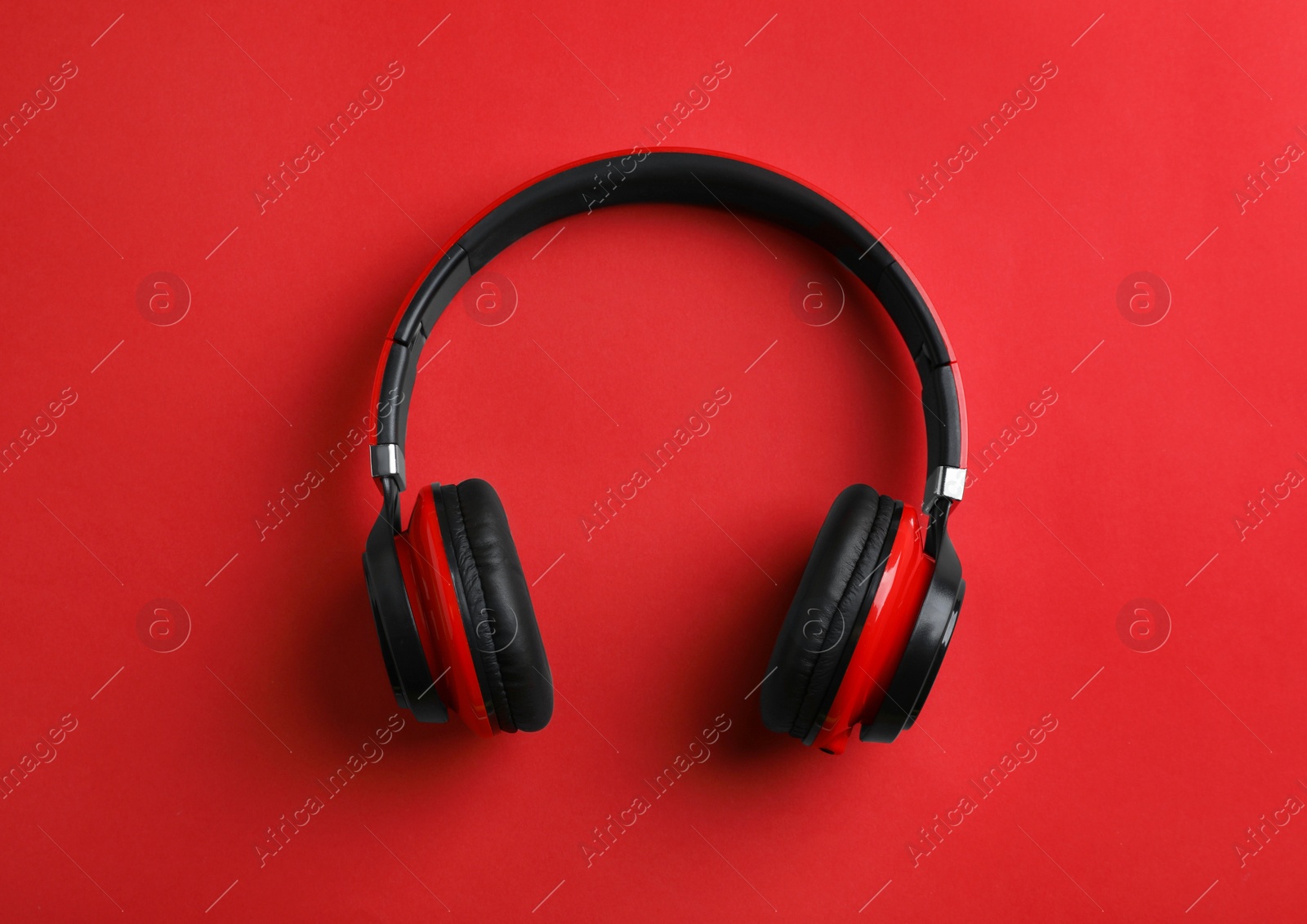 Photo of Wireless headphones on color background, top view