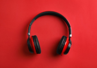 Photo of Wireless headphones on color background, top view