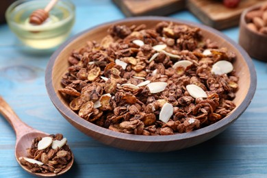 Tasty granola with nuts and dry fruits on light blue wooden table, closeup