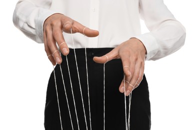 Photo of Woman in formal outfit pulling stringspuppet on white background, closeup