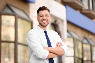 Portrait of young businessman in stylish outfit outdoors