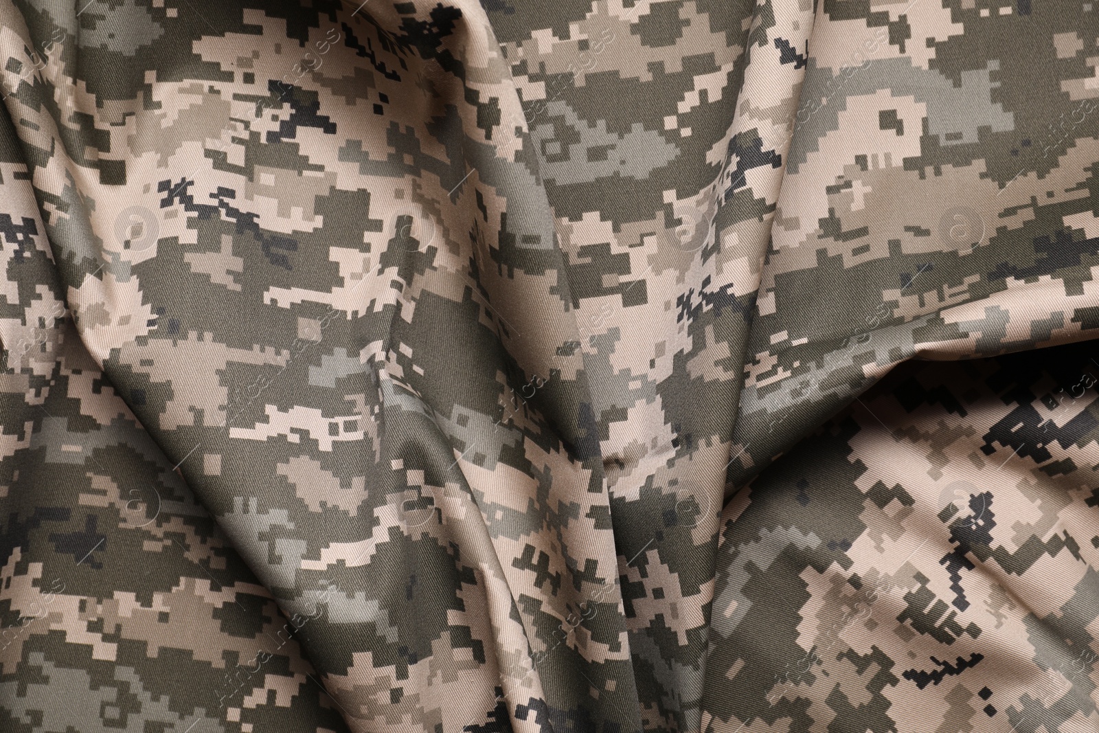 Photo of Texture of crumpled camouflage fabric as background, top view