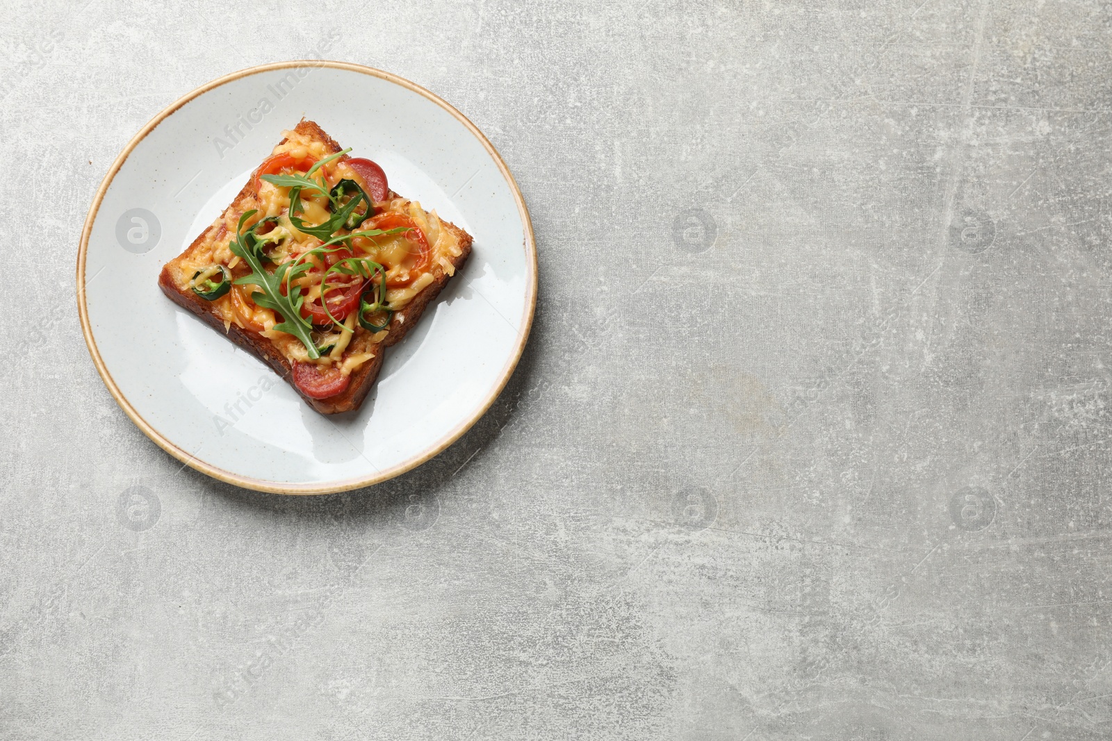 Photo of Tasty pizza toast on grey table, top view. Space for text