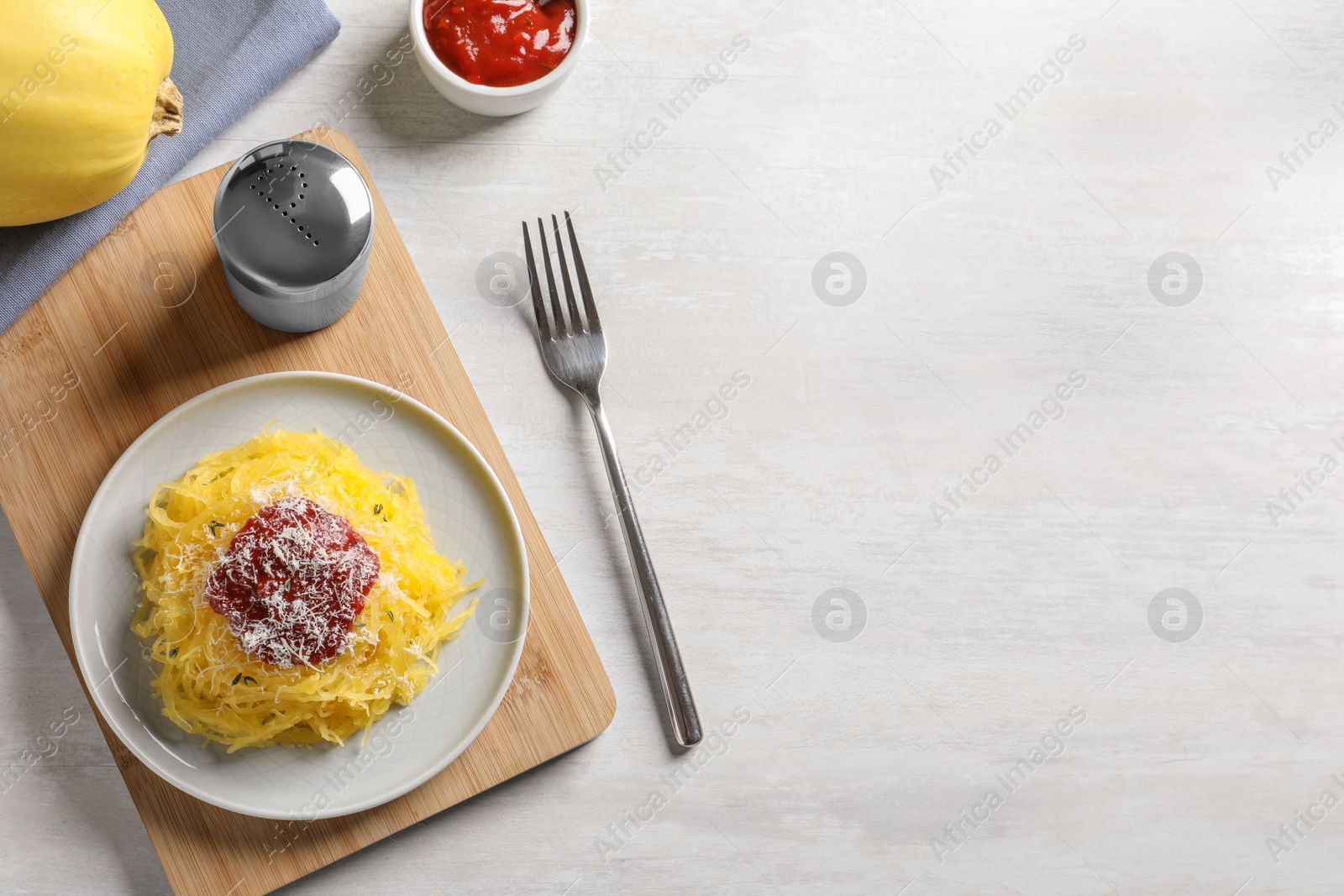 Photo of Flat lay composition with cooked spaghetti squash and space for text on white table