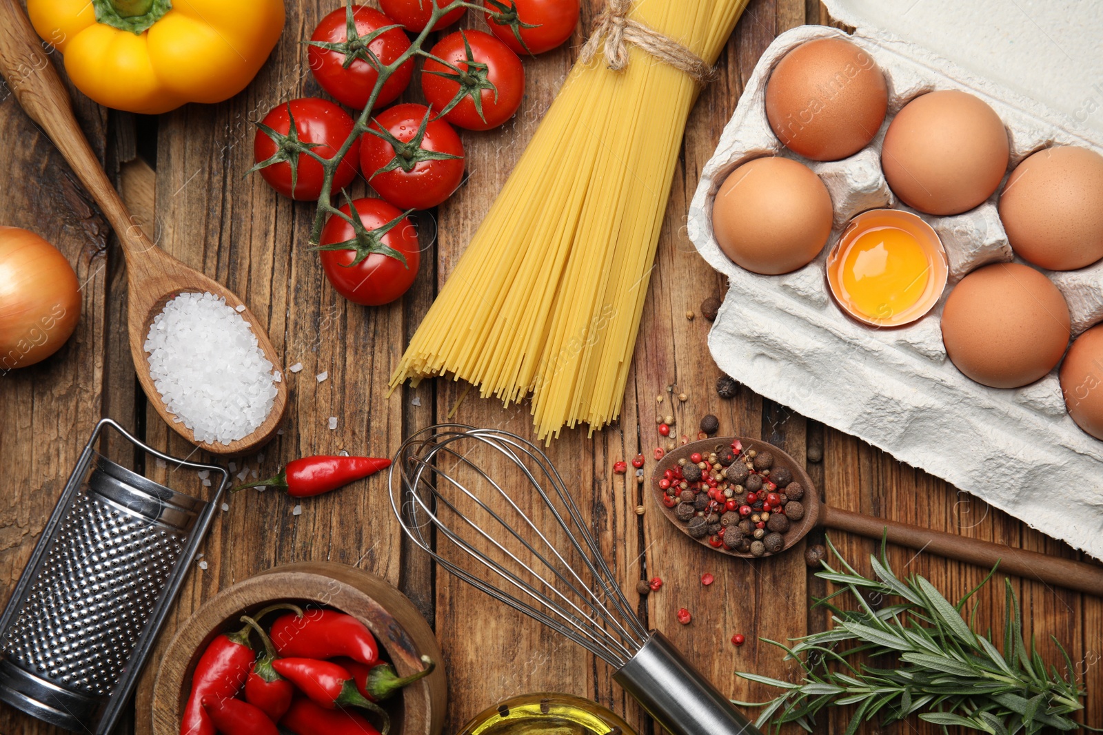 Photo of Flat lay composition with cooking utensils and fresh ingredients on wooden table