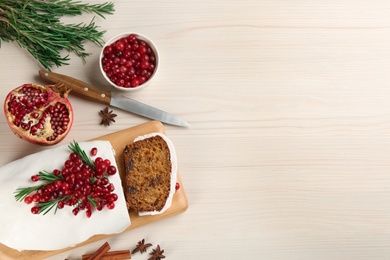 Flat lay composition with traditional classic Christmas cake on white wooden table. Space for text