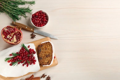 Photo of Flat lay composition with traditional classic Christmas cake on white wooden table. Space for text