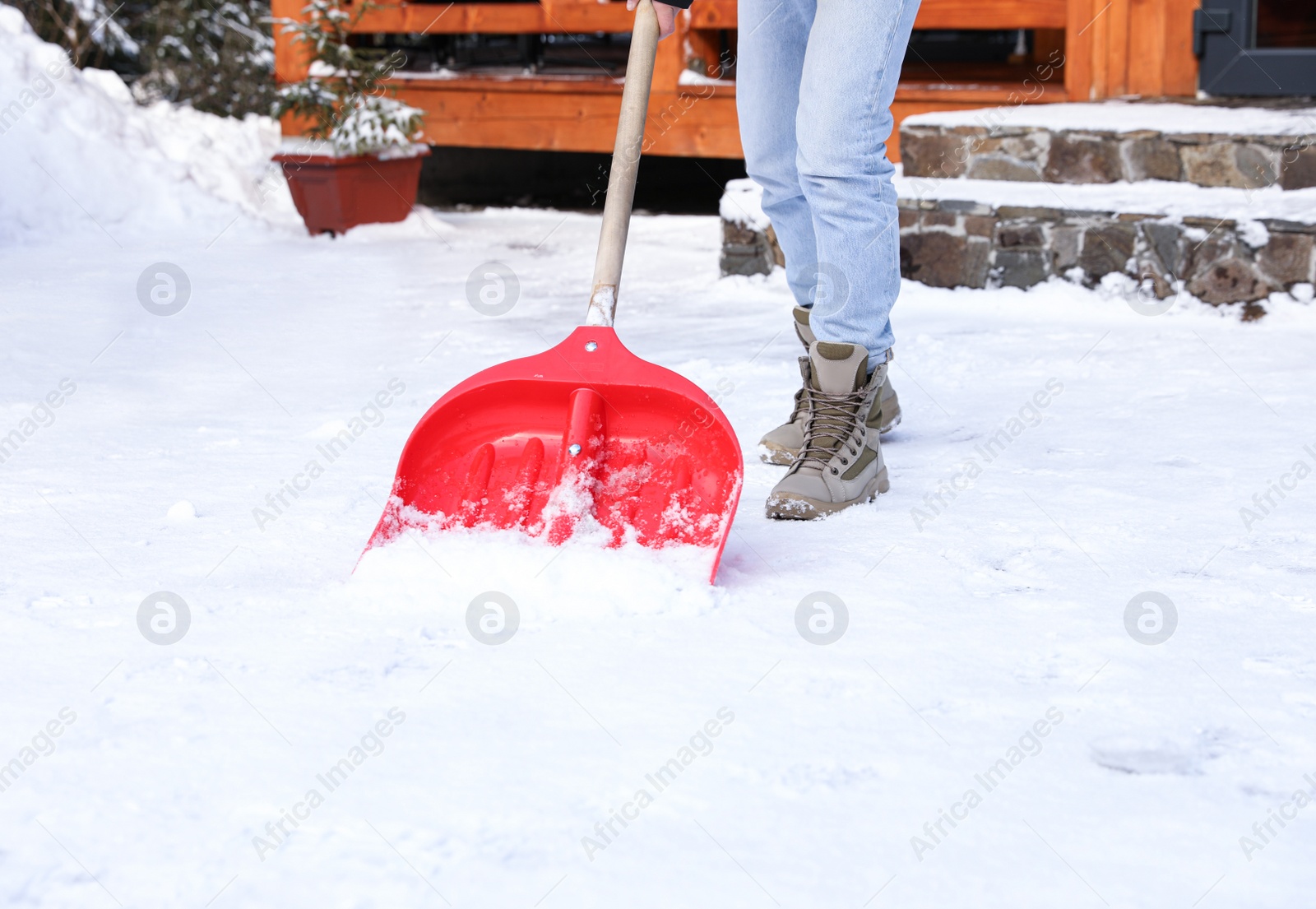 Photo of Man removing snow with shovel on winter day, closeup