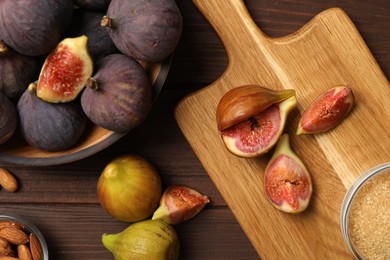 Tasty raw figs on wooden table, flat lay