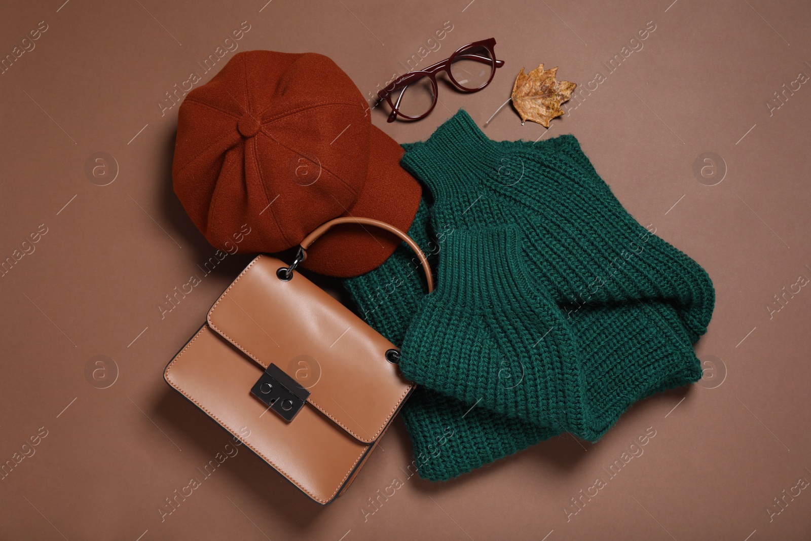 Photo of Flat lay composition with stylish hat on brown background
