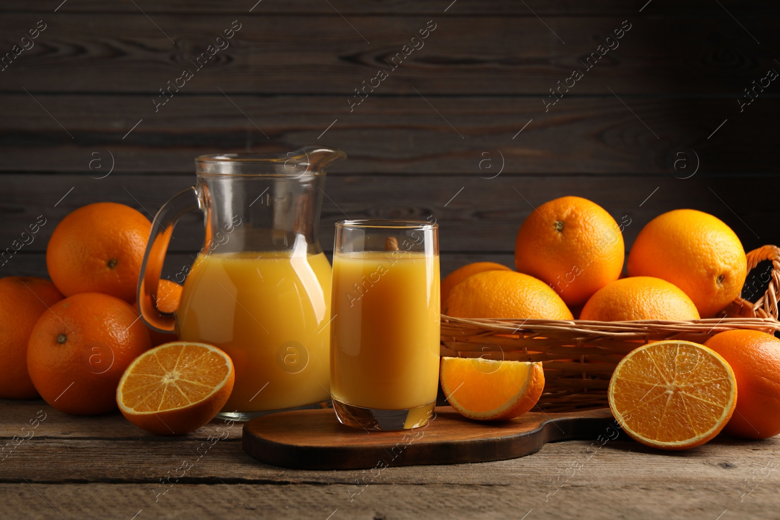 Photo of Tasty fresh oranges and juice on wooden table