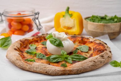 Photo of Delicious pizza with burrata cheese and basil on table, closeup