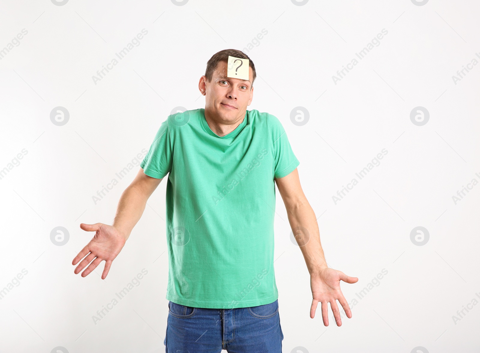 Photo of Emotional man with question mark on white background