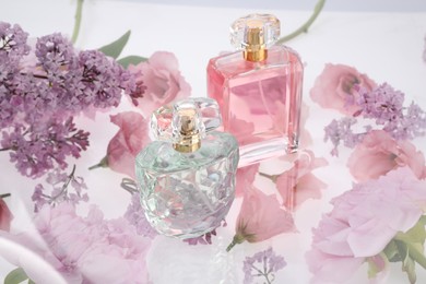 Photo of Two luxury perfumes on spring floral decor