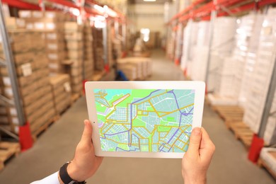 Image of Man with tablet at warehouse, closeup. Wholesale business