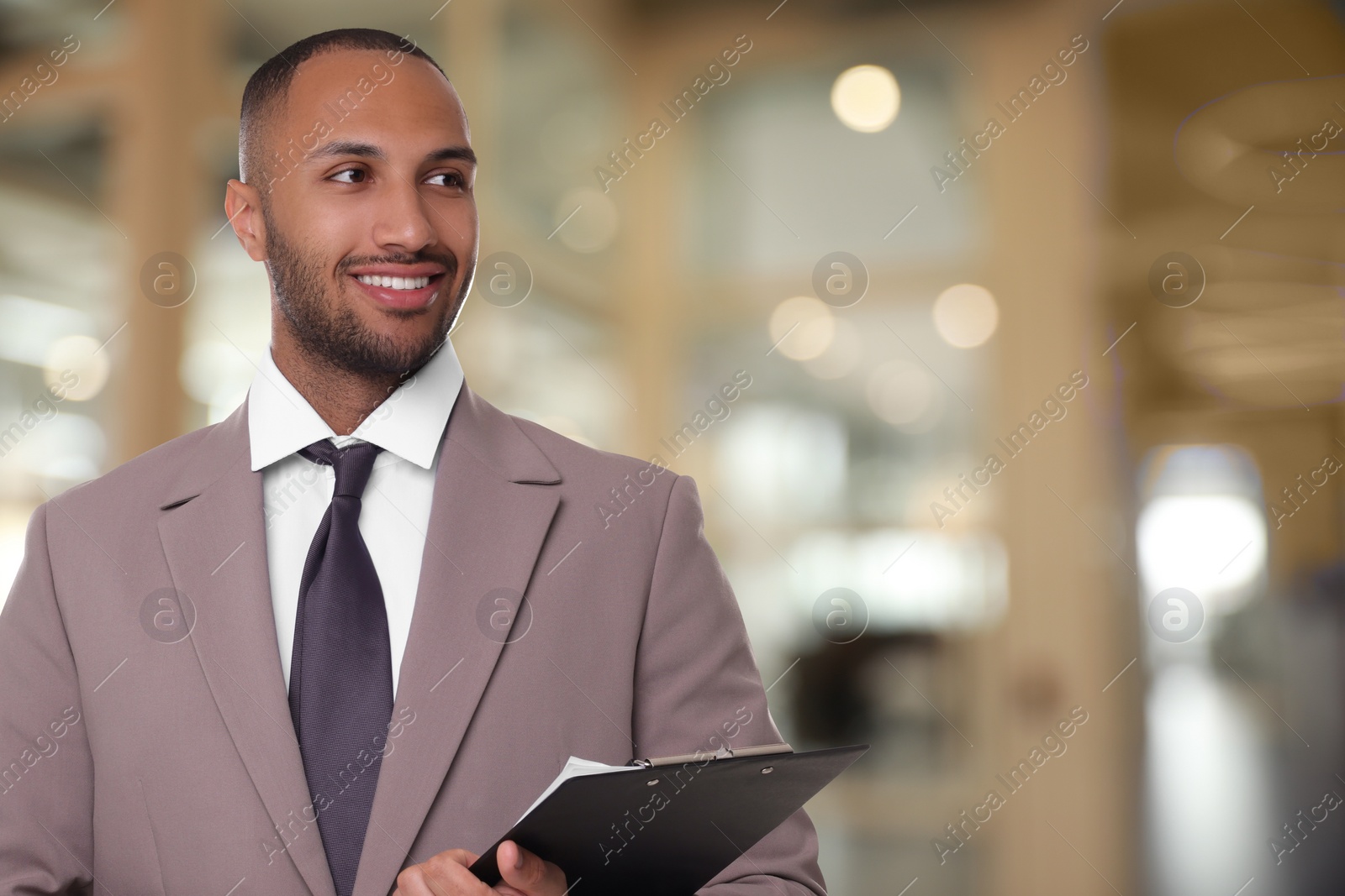 Image of Lawyer, consultant, business owner. Confident man with clipboard smiling indoors, space for text