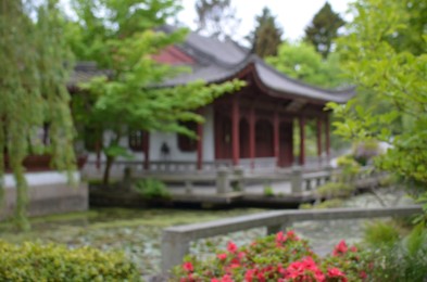 Photo of Beautiful view of oriental building near pond in park