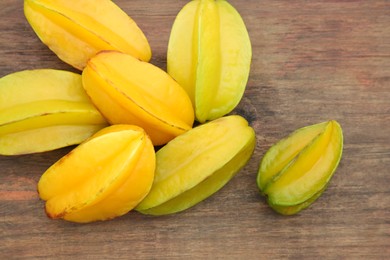 Delicious ripe carambolas on wooden table, closeup