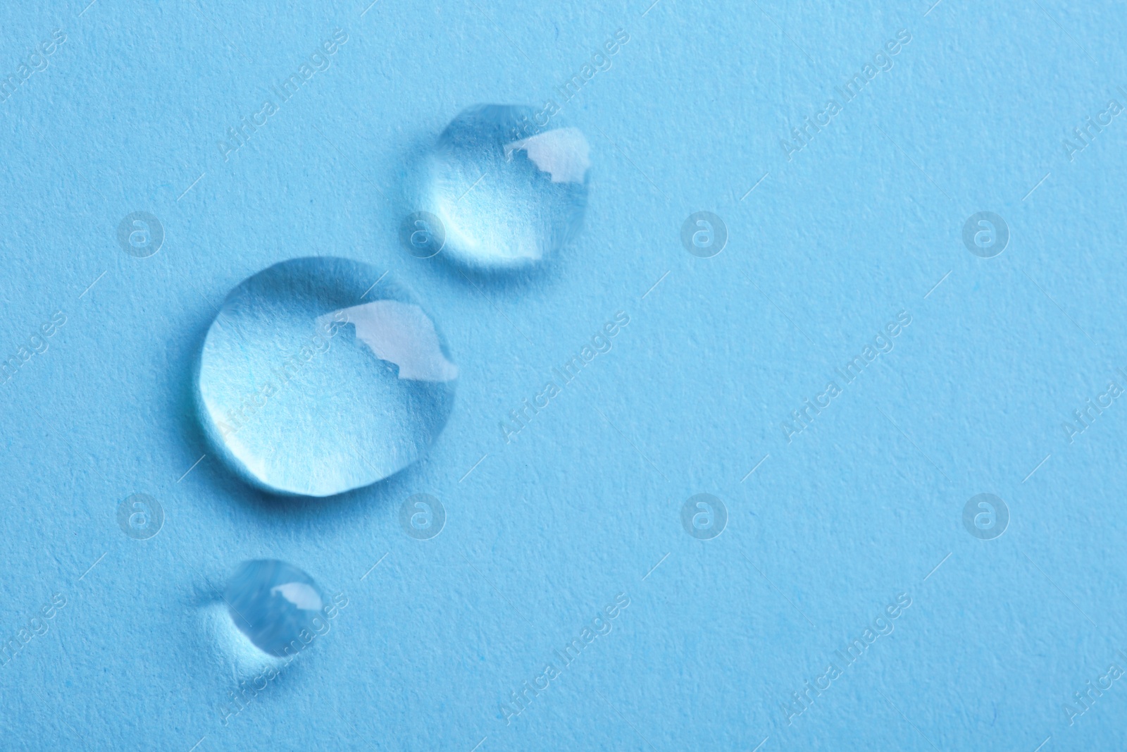 Photo of Water drops on color background, top view. Space for text
