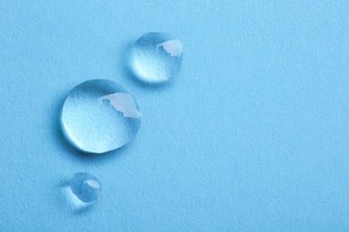 Water drops on color background, top view. Space for text