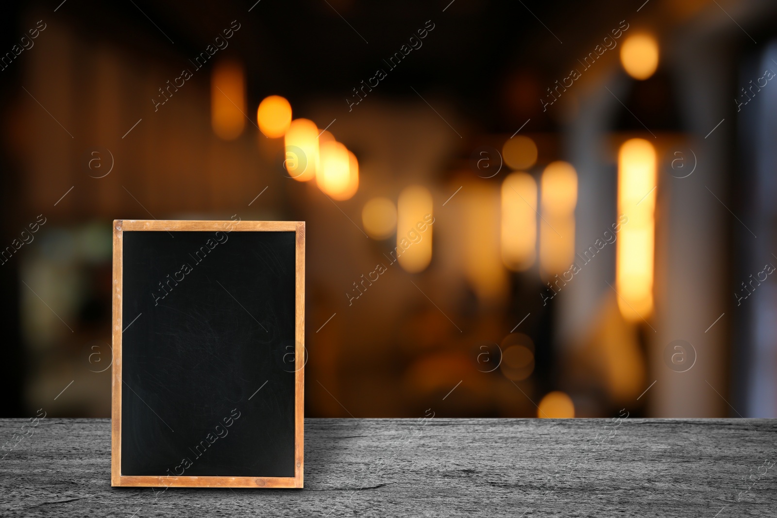 Image of Blank small blackboard on wooden table in cafe, mockup for menu design 